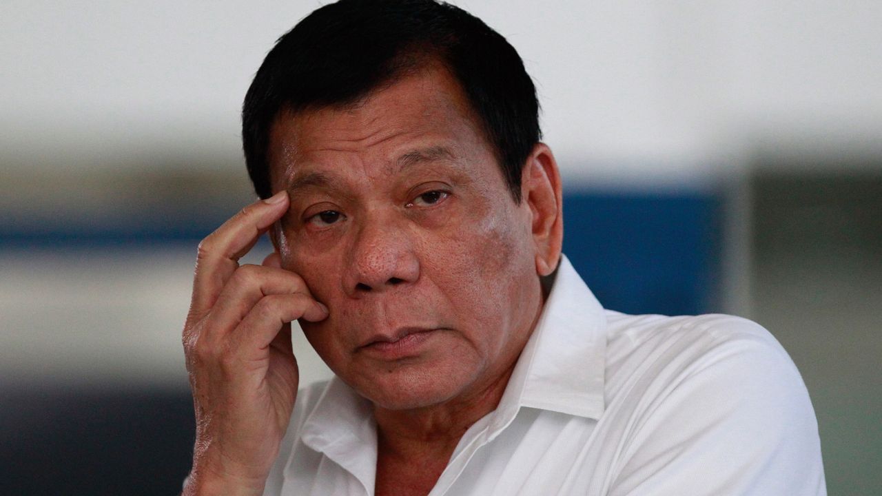 Then-Philippine President Rodrigo Duterte listens to a question from reporters at Manila's International Airport, Philippines on, Nov. 9, 2016. (AP Photo/Aaron Favila, File)