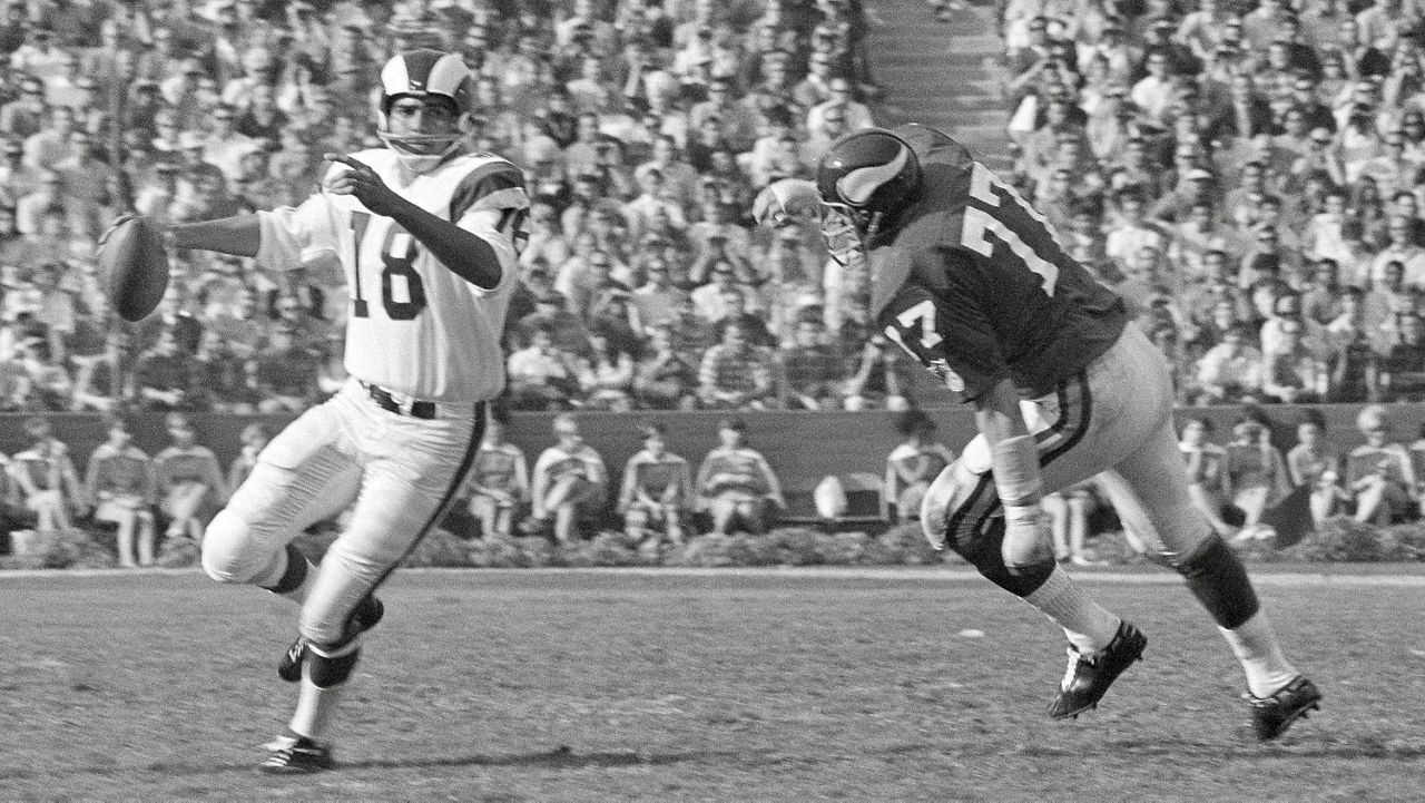 Los Angeles Rams quarterback Roman Gabriel fades back to pass as a Minnesota Viking defenseman closes in during their NFL game at the Coliseum in Los Angeles, Dec. 7, 1969. Gabriel was chosen Most Valuable Player in the NFL in a poll taken by The Associated Press of 48 writers and broadcasters in the 16 NFL cities. (AP Photo/Harry Harris)