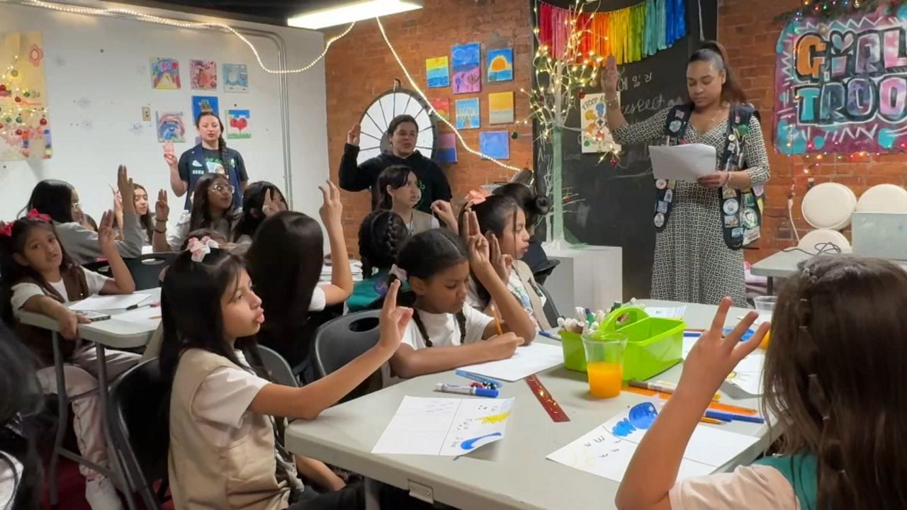 Girl Scout Troop 6000 serves children living at The Row hotel, which has been a home for hundreds of migrant families in the last year.