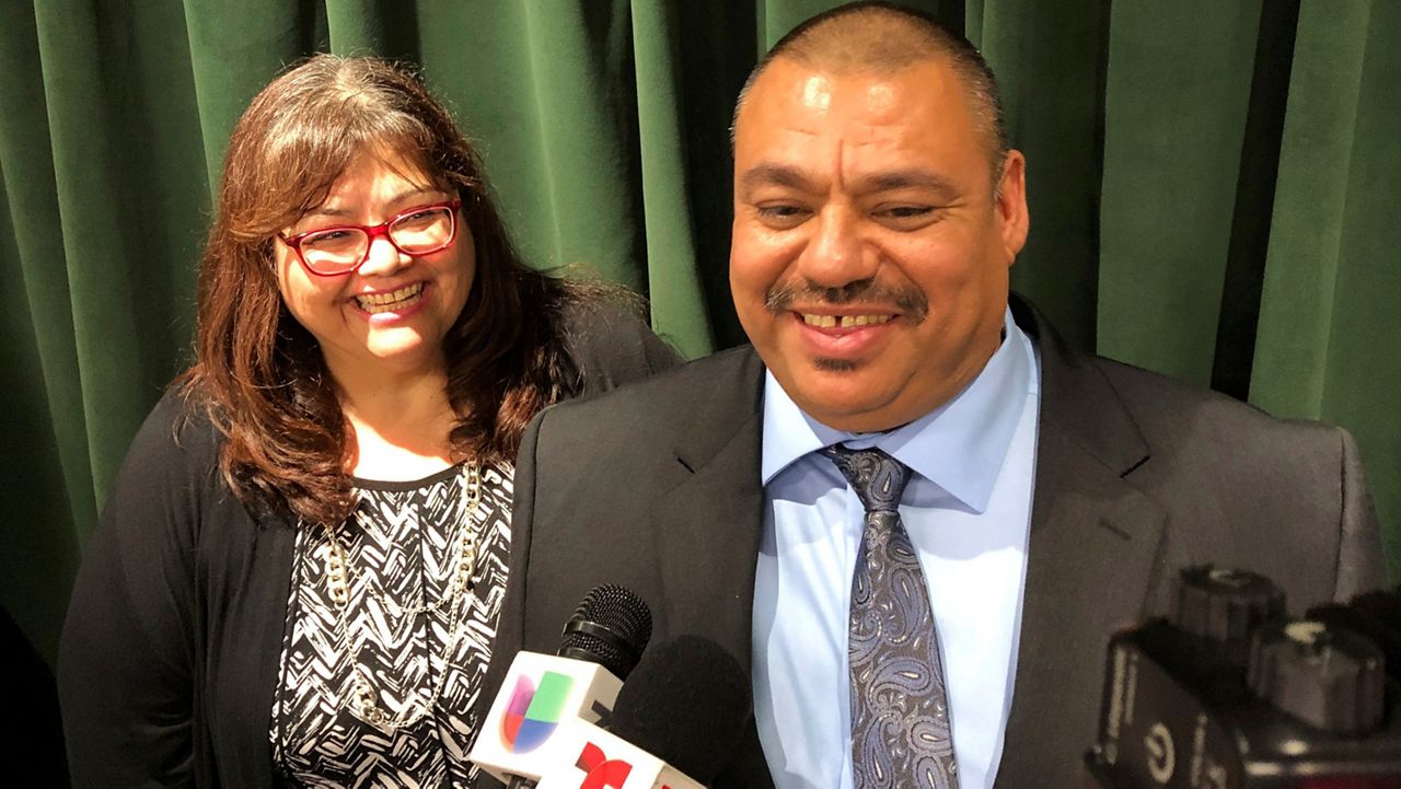 Ruben Martinez Jr., right, and his wife, Maria, left, talk to reporters at the Hall of Justice in downtown Los Angeles, on Tuesday, Nov. 12, 2019. (AP Photo/Brian Melley)
