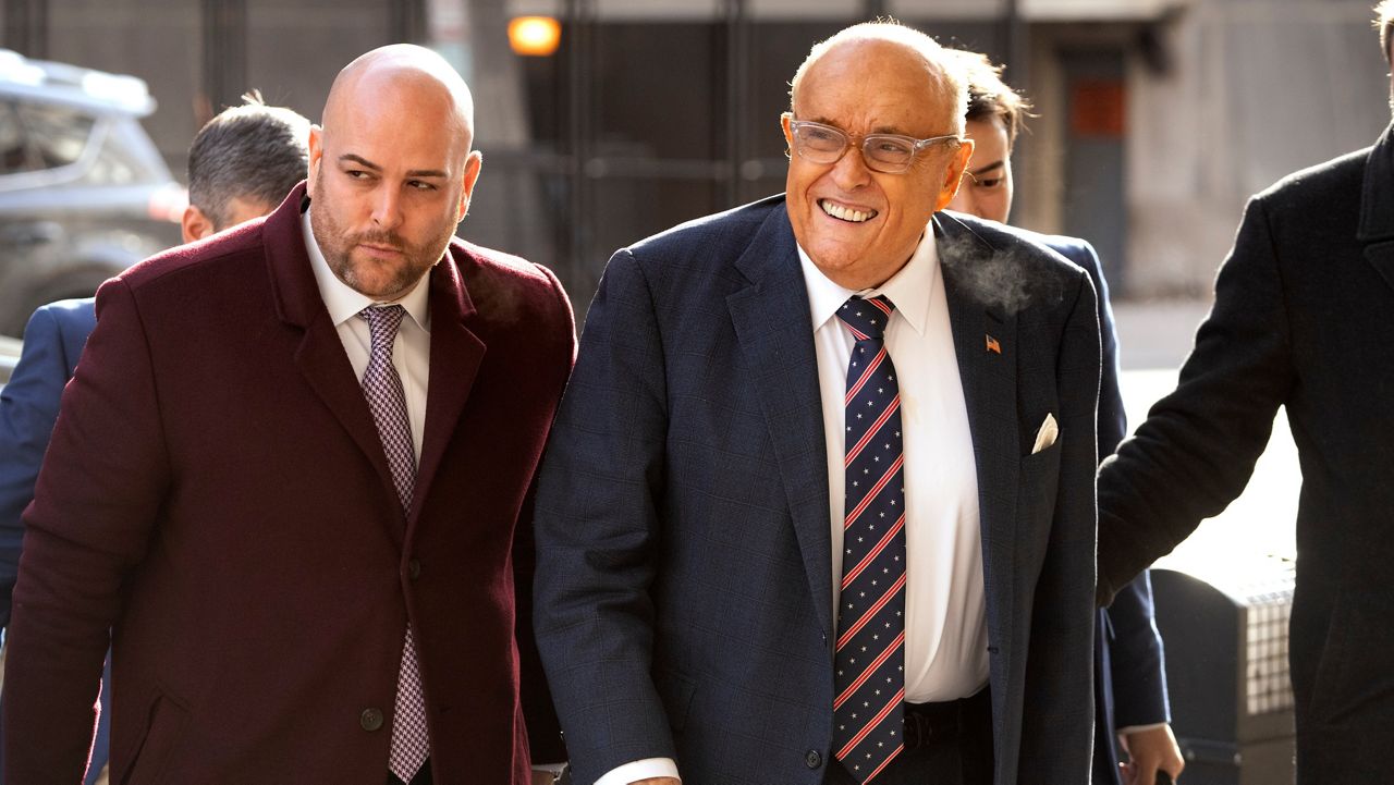 Rudy Giuliani, right, arrives at federal court in Washington, Friday, Jan. 10, 2025. (AP Photo/Mark Schiefelbein)