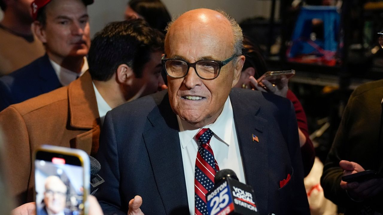 Rudy Giuliani speaks to reporters after Republican presidential candidate former President Donald Trump spoke at a primary election night party in Nashua, N.H., Tuesday, Jan. 23, 2024. (AP Photo/Matt Rourke)