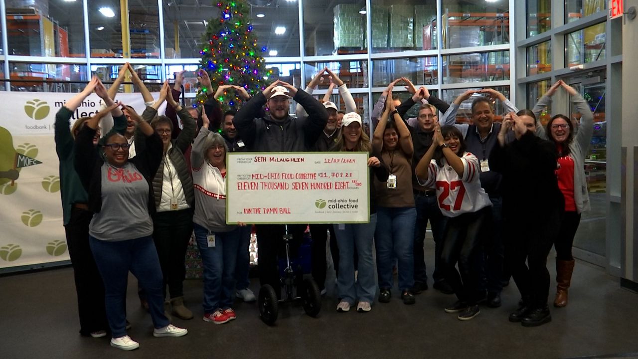 Employees at the food bank do an O-H-I-O chant with Seth.