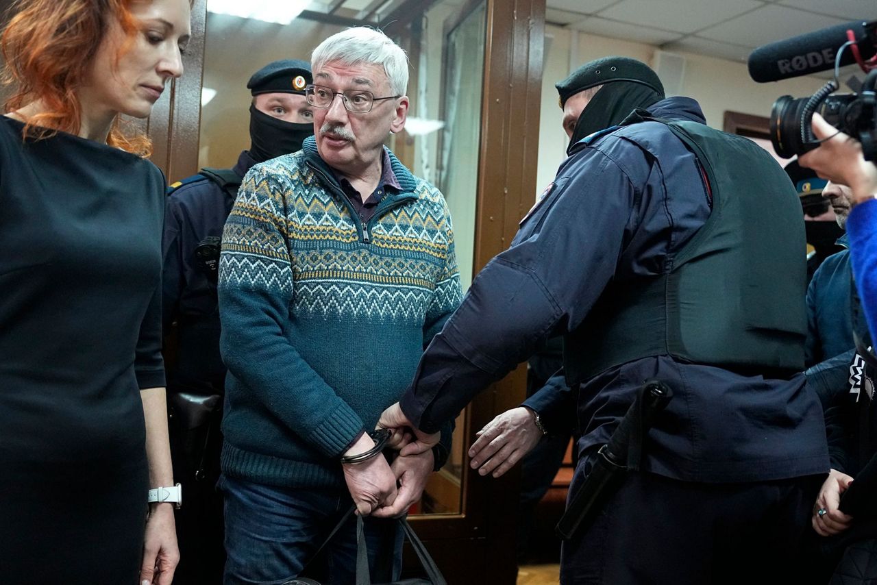 A Russian court sentences the co-chair of a Nobel-winning rights group ...