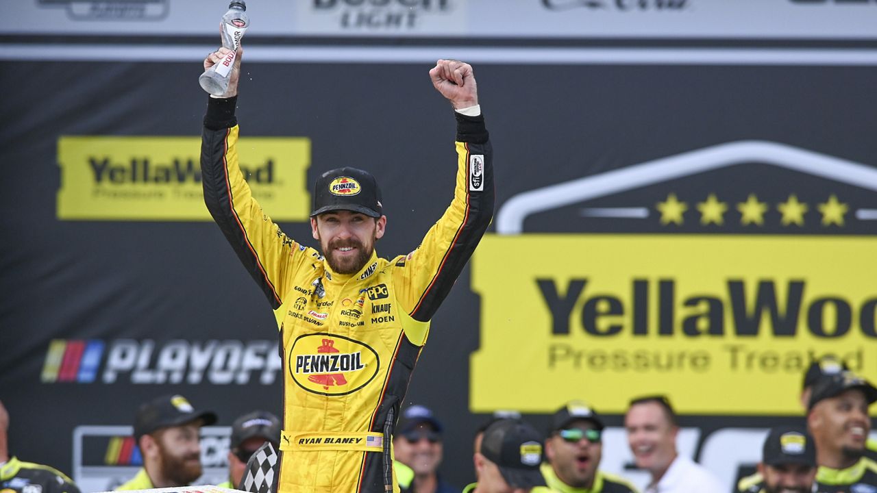 Ryan Blaney, front left, celebrates after winning a NASCAR Cup Series auto race at Talladega Superspeedway, Sunday, Oct. 1, 2023, in Talladega, Ala. (AP Photo/Julie Bennett)