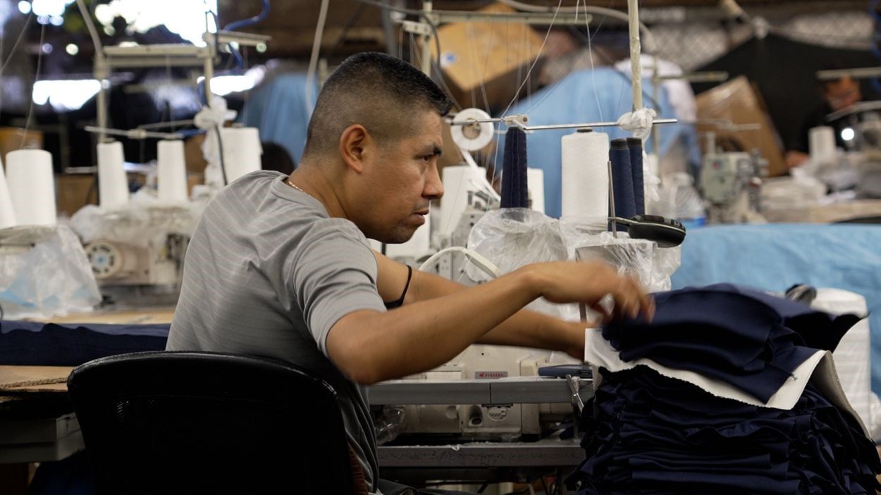 A seamster sews garments at Everywhere Apparel's south Los Angeles production facility. (Spectrum News/Ryan Thompson)