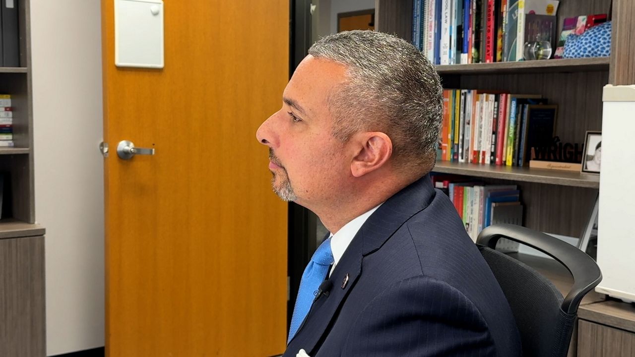 Bo Wright listens to someone speaking in his office