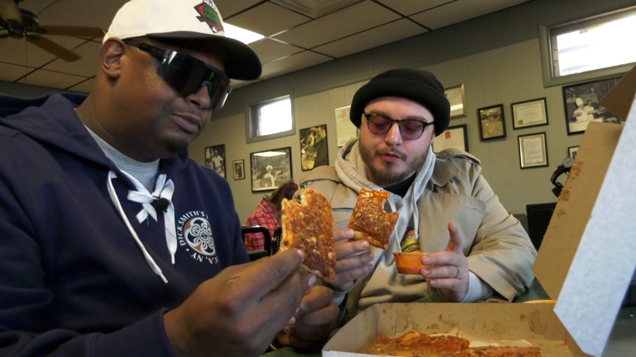 Eat Local food critics look at slices of pizza they're about to eat