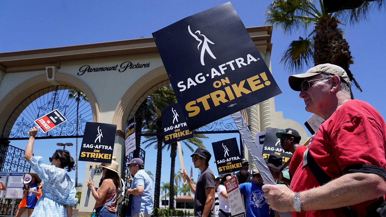 Striking writers and actors picket outside Paramount studios in Los Angeles on Friday, July 14, 2023. This marks the first day actors formally joined the picket lines, more than two months after screenwriters began striking in their bid to get better pay and working conditions. (AP Photo/Chris Pizzello)