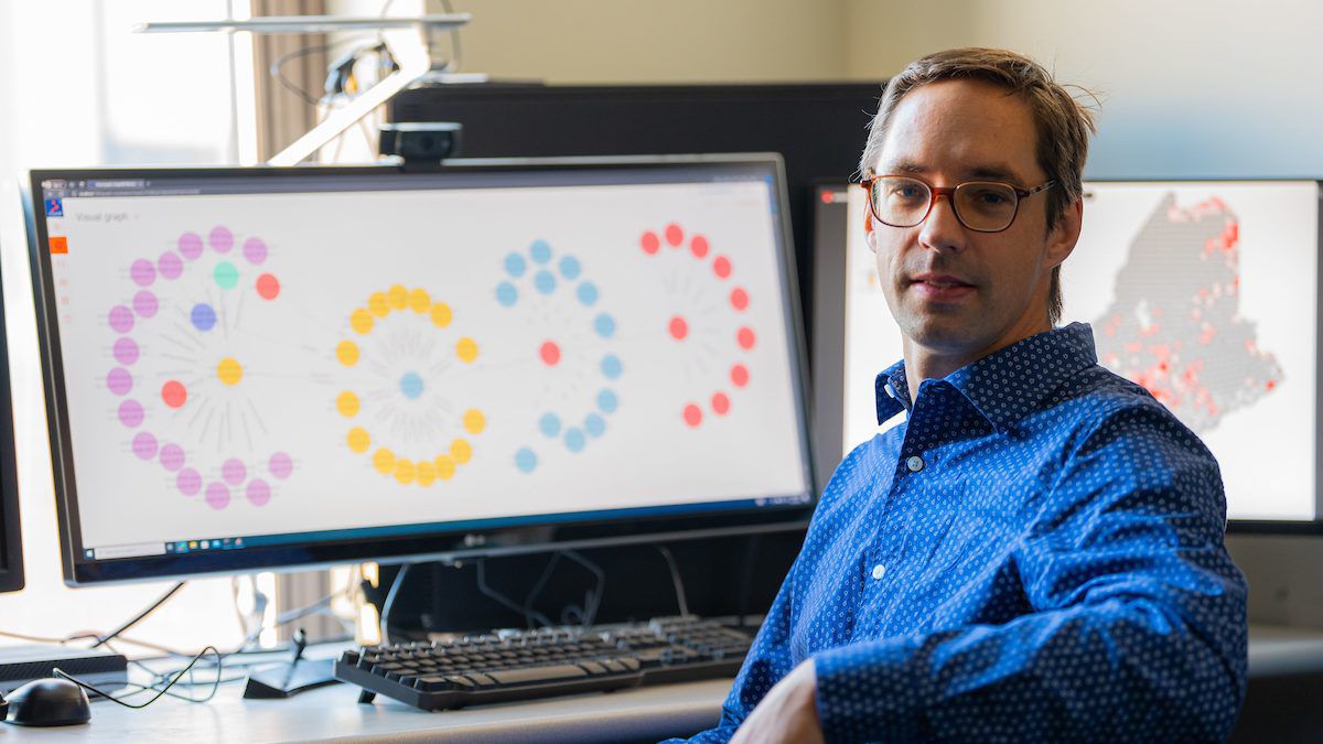 University of Maine computer scientist Torsten Hahmann with a prototype of a new PFAS tracking tool he's developing called Safe Agricultural Products and Water Graph (SAWGraph). Photo courtesy of the University of Maine.