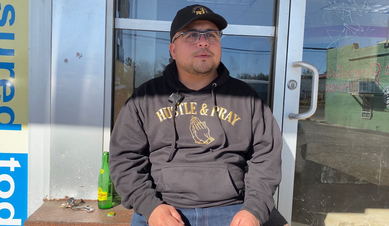 David "Davy" Espinoza sits near a corner store on San Antonio's West Side where he learned about entrepreneurship. (Spectrum News 1/Jose Arredondo)