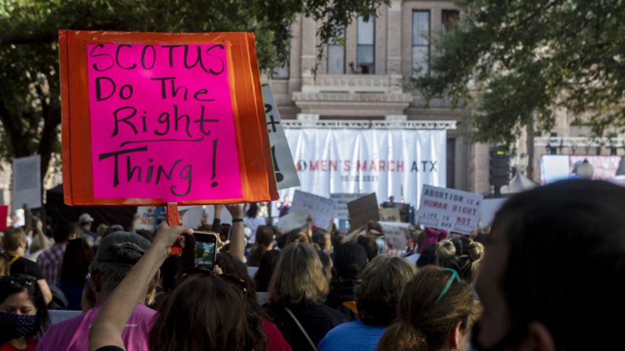 People attend the Women's March ATX rally, Oct., 2, 2021, at the Texas State Capitol in Austin, Texas. The Texas Supreme Court on Friday paved the way for the nation's toughest abortion law to remain in place in a ruling that again deflated clinics' hopes of stopping — or even pausing — the restrictions anytime soon. (AP Photo/Stephen Spillman, File)