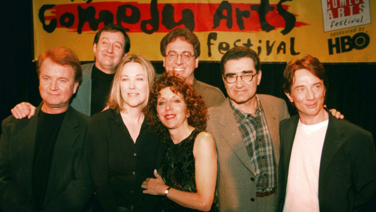 Former cast members of SCTV reunited at the U.S. Comedy Arts Festival Saturday night, March 6, 1999, in Aspen, Colo. From left front row are: Dave Thomas; Catherine O'Hara; Andrea Martin; Eugene Levy; and Martin Short. In the back row are Joe Flaherty, left, and Harold Ramis. (AP Photo/E Pablo Kosmicki)