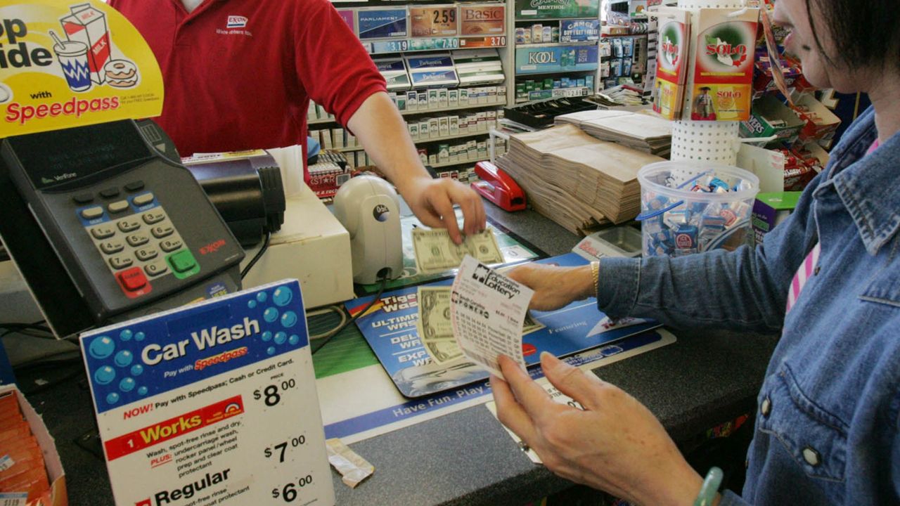 Cashier helps customer with the purchase of a South Carolina Education Lottery ticket. 