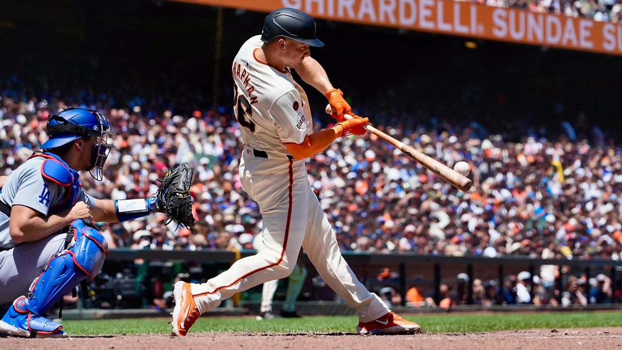 San Francisco Giants' Matt Chapman, right, hits a two-run home run against the Los Angeles Dodgers during the fourth inning of a baseball game Sunday, June 30, 2024, in San Francisco. (AP Photo/Godofredo A. Vásquez)