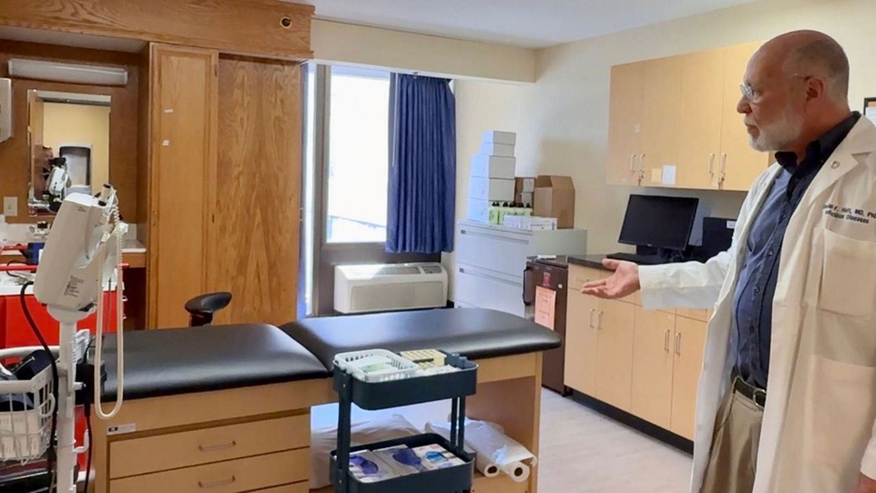 Dr. Daniel Hoft, director of SLU’s Vaccine Center, shows off one of the medical exam rooms at the Extended Stay Research Unit where participants will be infected with influenza A as part of a study. (Spectrum News/Elizabeth Barmeier)