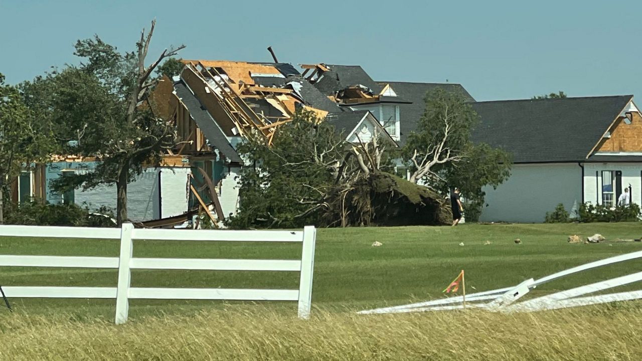 Dazed residents sift through homes mangled by a tornado