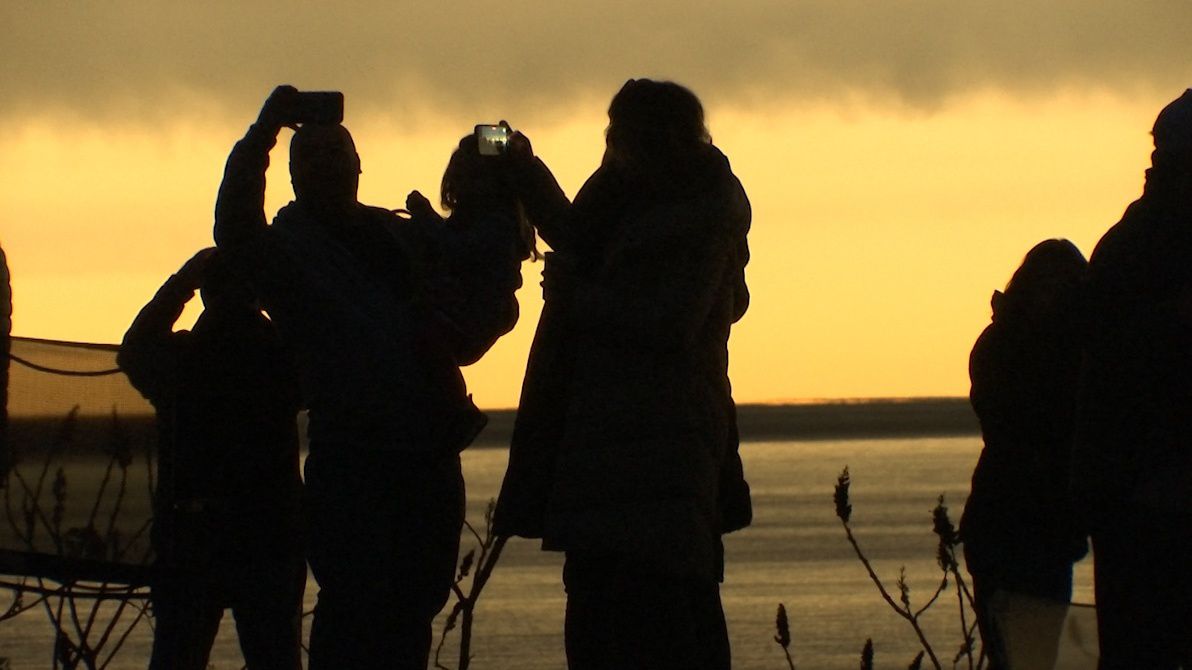 People in Sodus Point take in the total solar eclipse. (Spectrum News 1)
