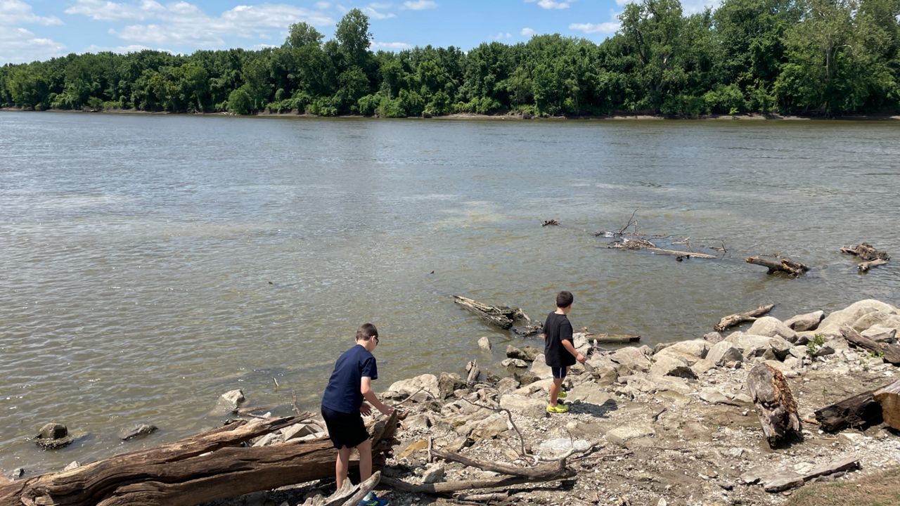 Two boys explore the Mississippi River along the shoreline at Riverside Landing Park in St. Charles, Mo.