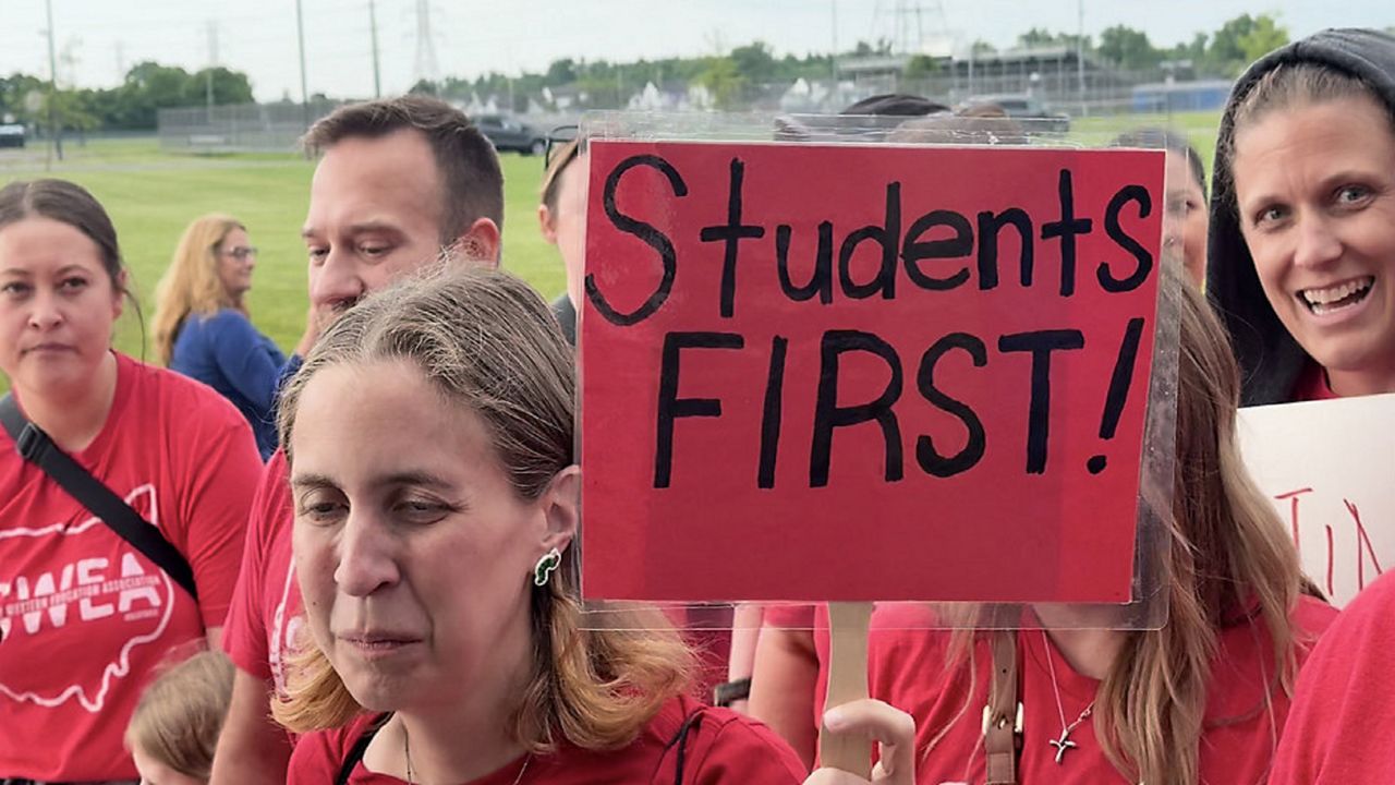 Parents and community members march to the South Western City School Board meeting, voicing concerns about transparency, student equity and the future of public education in the district. (Spectrum News 1/Saima Khan).