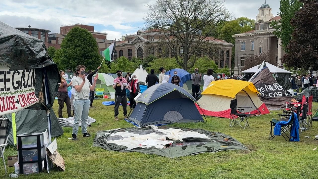 Pro-Palestinian protesters chanting at their encampment during graduation at Syracuse University  (Justin Velazquez, Spectrum News 1)