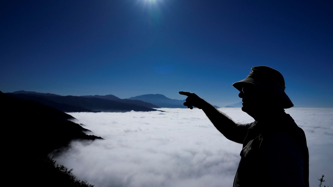 Gary Earney, a retired forester with the U.S. Forest Service, looks for springs that serve as the headwaters of Strawberry Creek in San Bernardino National Forest on Monday, Sept. 18, 2023, in San Bernardino, Calif. (AP Photo/Ashley Landis)