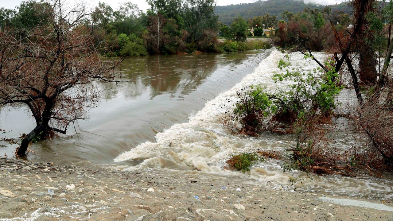 Stormwater runoff cascades over a spillway in the San Gabriel River in El Monte, Calif. (AP Photo/Nick Ut)