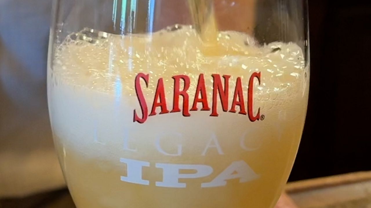 Beer is poured into a Saranac glass
