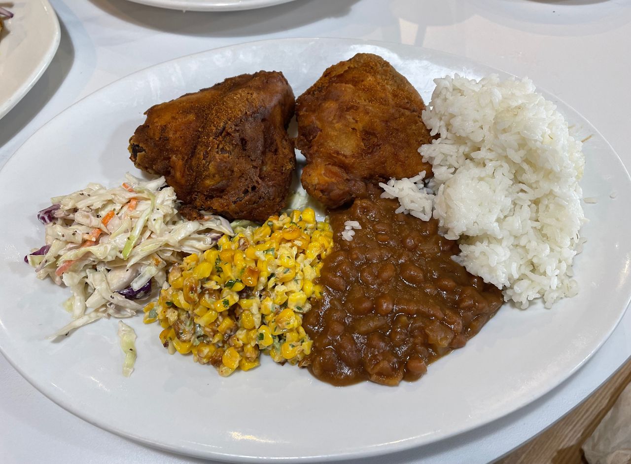 The Southern Fried Chicken Plate comes with rice or cornbread, BBQ beans, corn salad, and Southern coleslaw.  (Spectrum News/Leann Vidal Thompson)