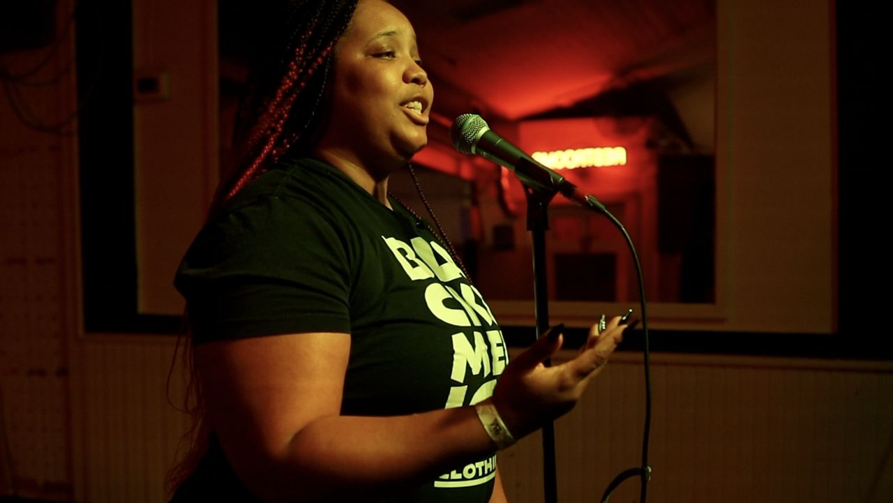 Mecca Miles recites a poem at Jandro's Patio Garden in San Antonio. 