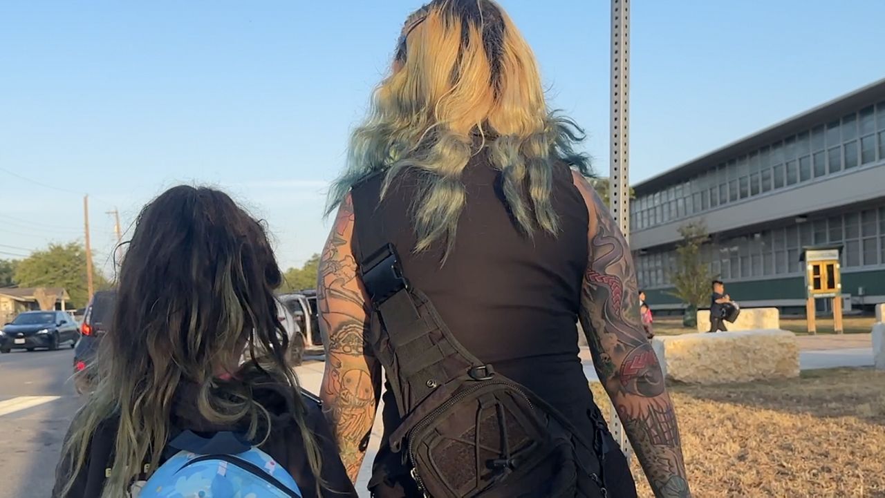 Vanessa Fears walks her daughter to school. 
