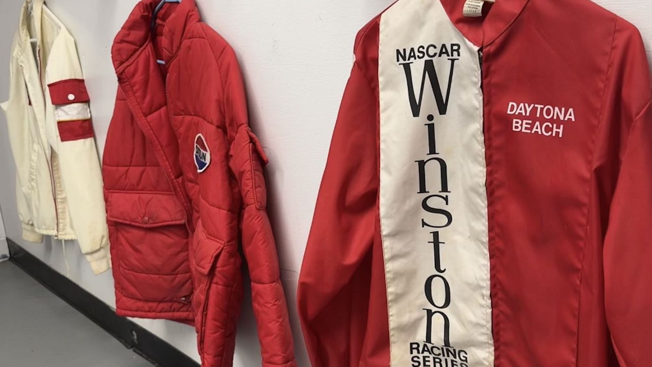 A few of Dean Combs' racing jackets that hang in his man cave.