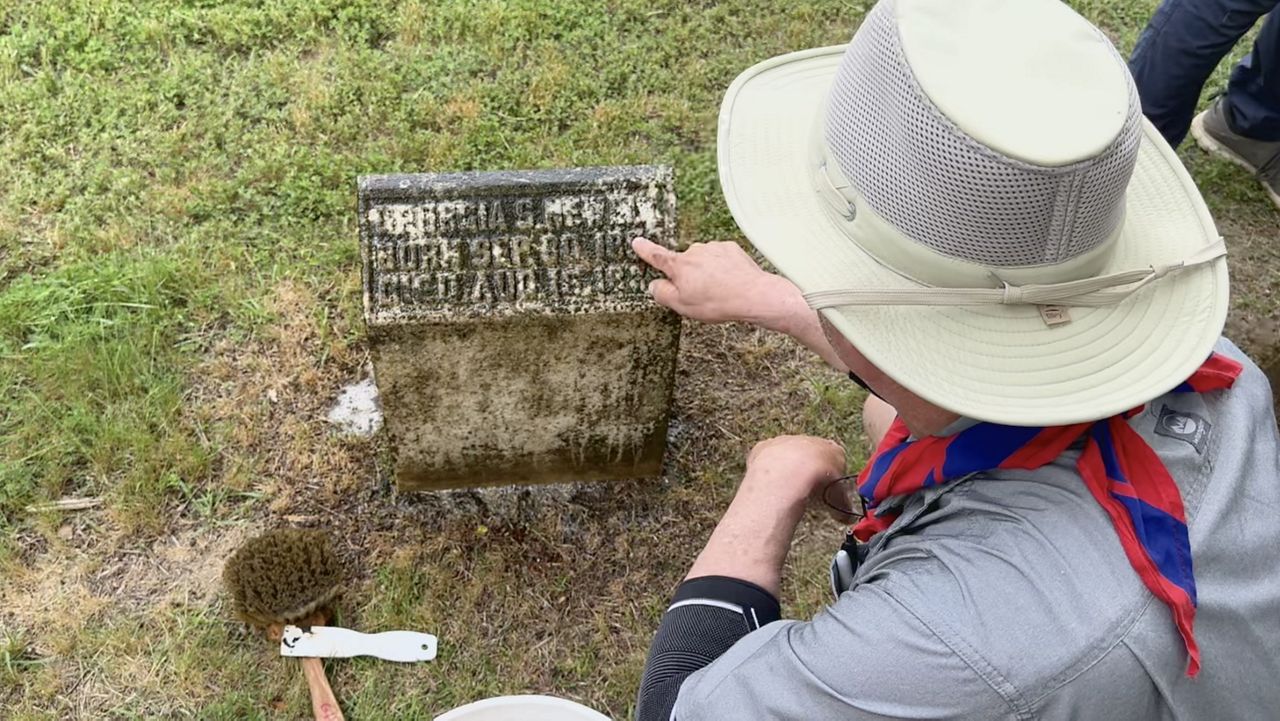 David Craft finally seeing words on Georgia's gravestone after some cleaning.