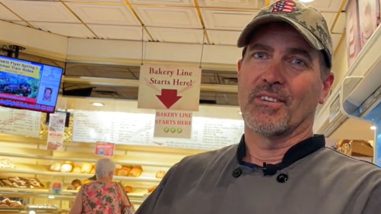 business owner in front of bakery