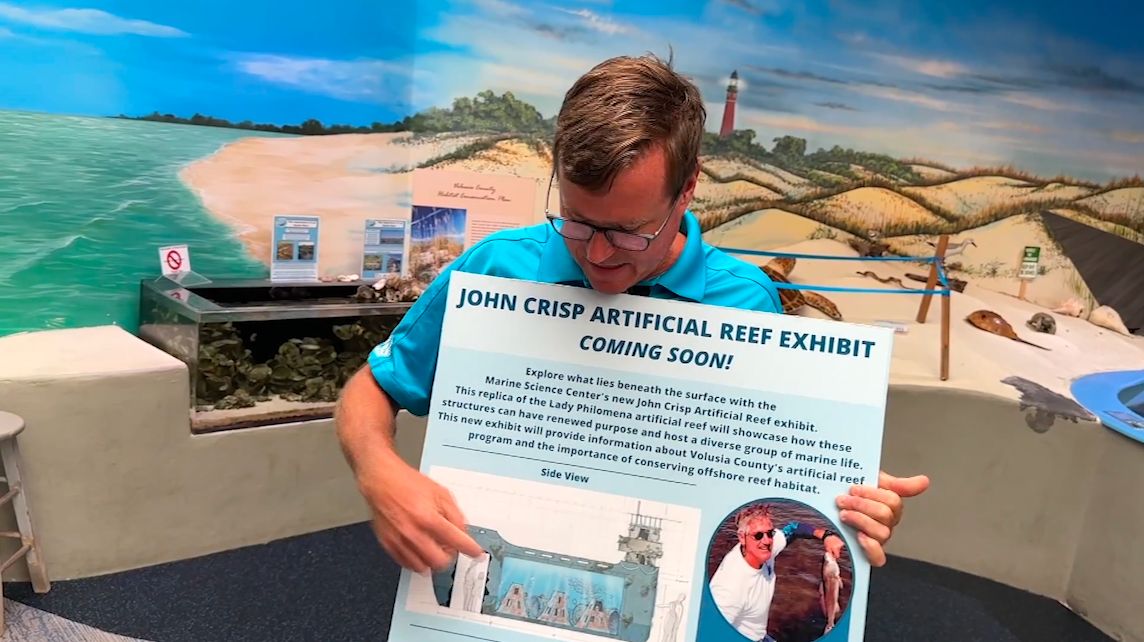 Marine Science Center manager Chad Macfie shows a rendering of the facility's new artificial reef exhibit. (Spectrum News)