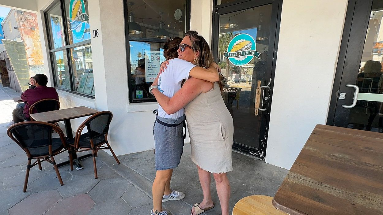 Maggie Leblanc hugging business owner, Eglantine Leguerchois. (Spectrum News)