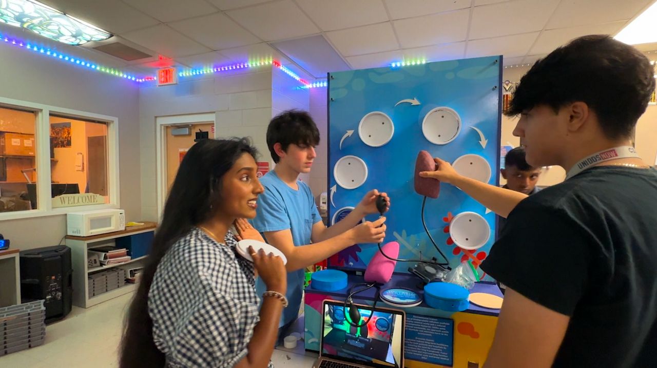 Sheena Kurakula's team collaborates about their project. (Spectrum Bay News 9/Julia Hazel)