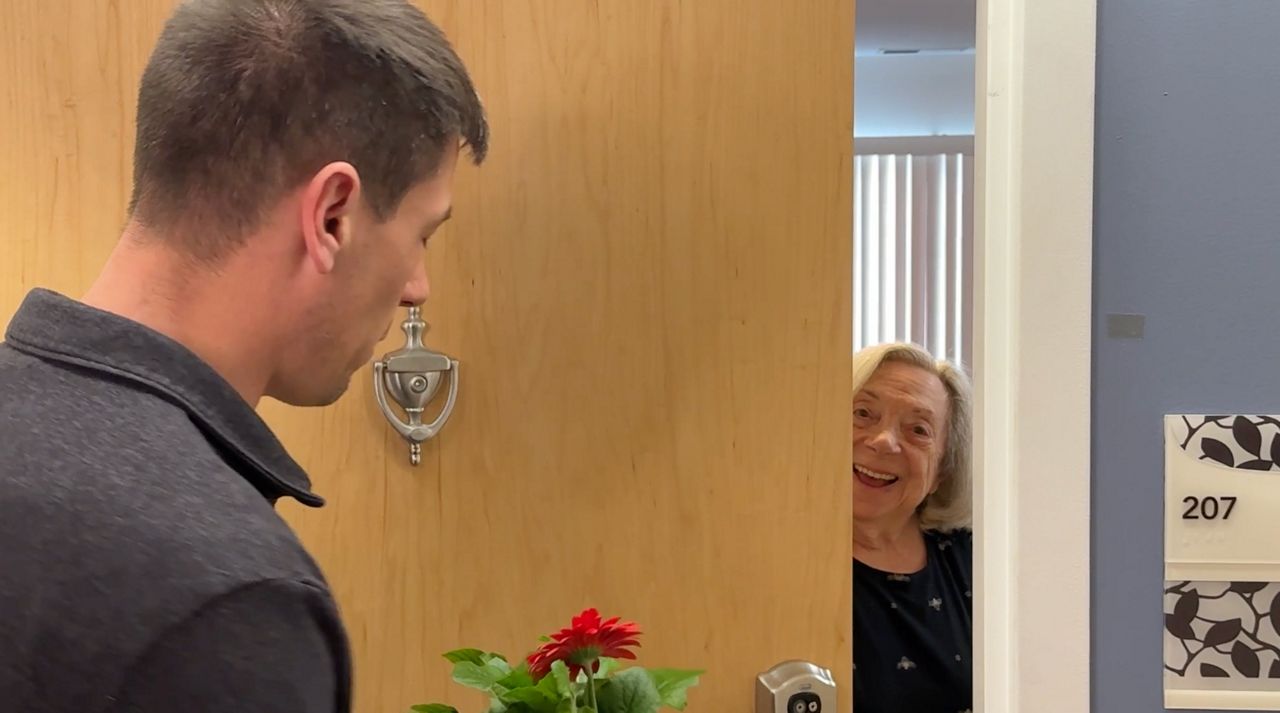 A mom is greeted at a door 