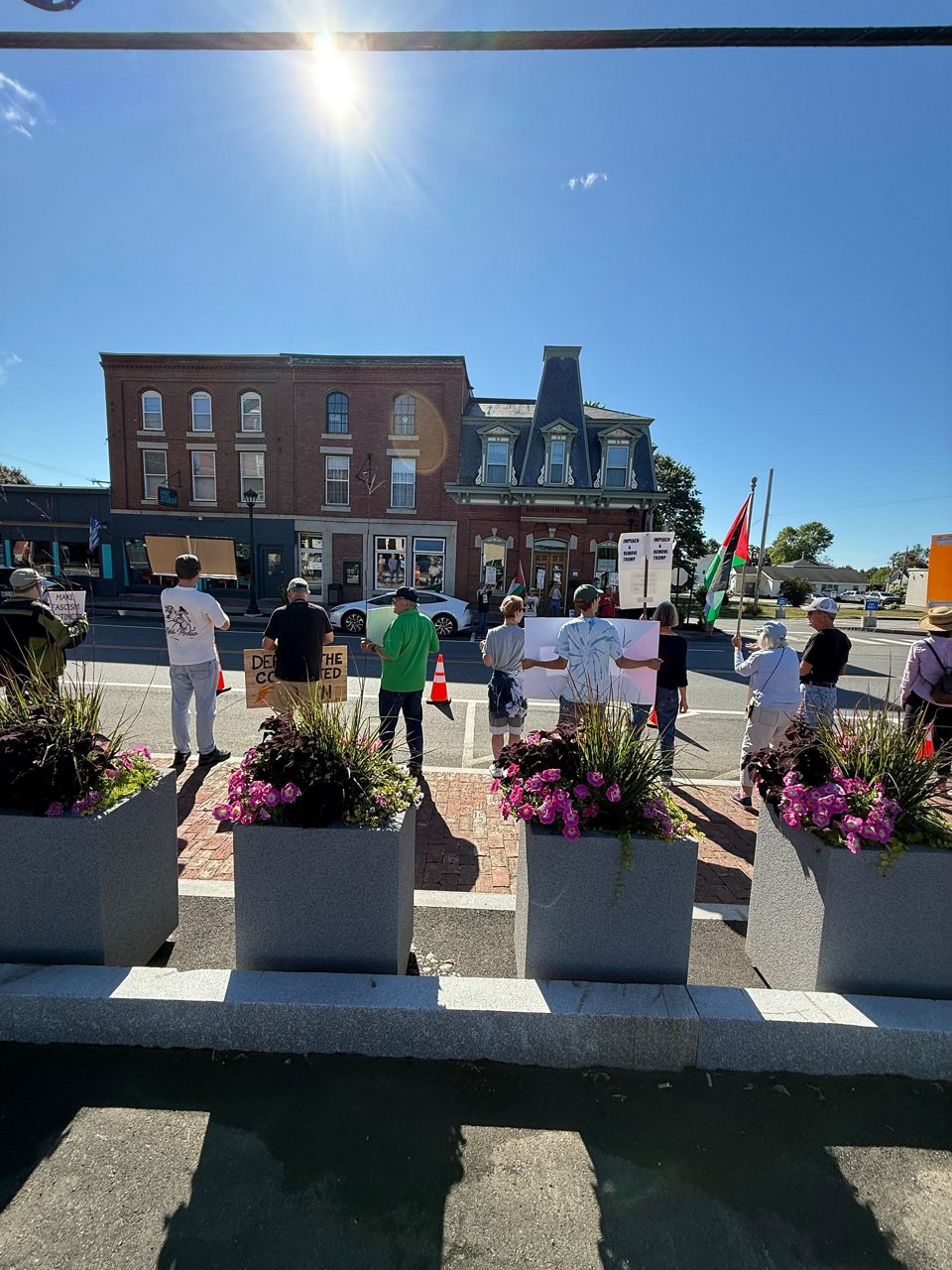 Protesters line a section of Route 1 outside of the Edwards Brothers Supermarket in Searsport prior to a ribbon-cutting for the road’s reconstruction. (Spectrum News/David Ledford)