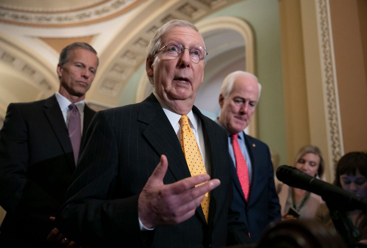 The Latest: McConnell slows push to name building for McCain