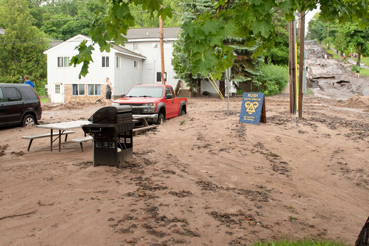 Death, washed-out roads amid flooding in Upper Midwest