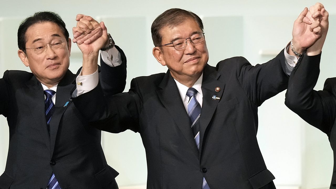 Shigeru Ishiba, right, with Japan's Prime Minister Fumio Kishida, left, and other candidates, celebrates after Ishiba was elected as new head of Japan's ruling Liberal Democratic Party during its leadership election Friday, Sept. 27, 2024, in Tokyo. (AP Photo/Hiro Komae, Pool)