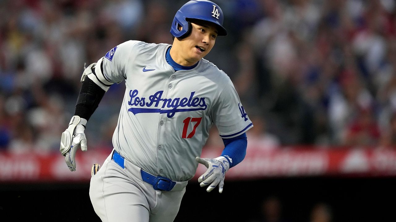 Los Angeles Dodgers' Shohei Ohtani heads to first for an RBI triple during the third inning of a baseball game against the Los Angeles Angels, Tuesday, Sept. 3, 2024, in Anaheim, Calif. (AP Photo/Mark J. Terrill)