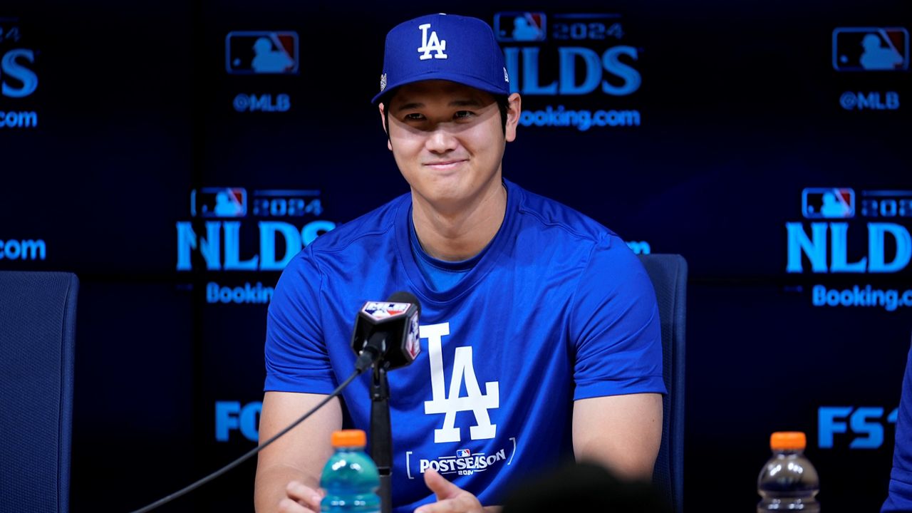 Los Angeles Dodgers' Shohei Ohtani speaks to reporters in a press conference in preparation for Game 1 of a baseball NL Division Series against the San Diego Padres in Los Angeles, Friday, Oct. 4, 2024. (AP Photo/Ashley Landis)