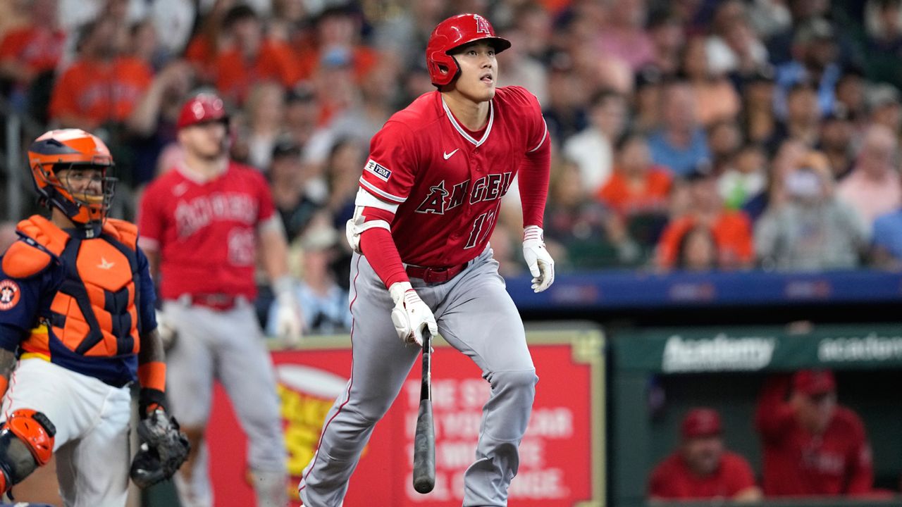 Los Angeles Angels' Shohei Ohtani watches his RBI double against the Houston Astros during the eighth inning of a baseball game Sunday, June 4, 2023, in Houston. (AP Photo/David J. Phillip)