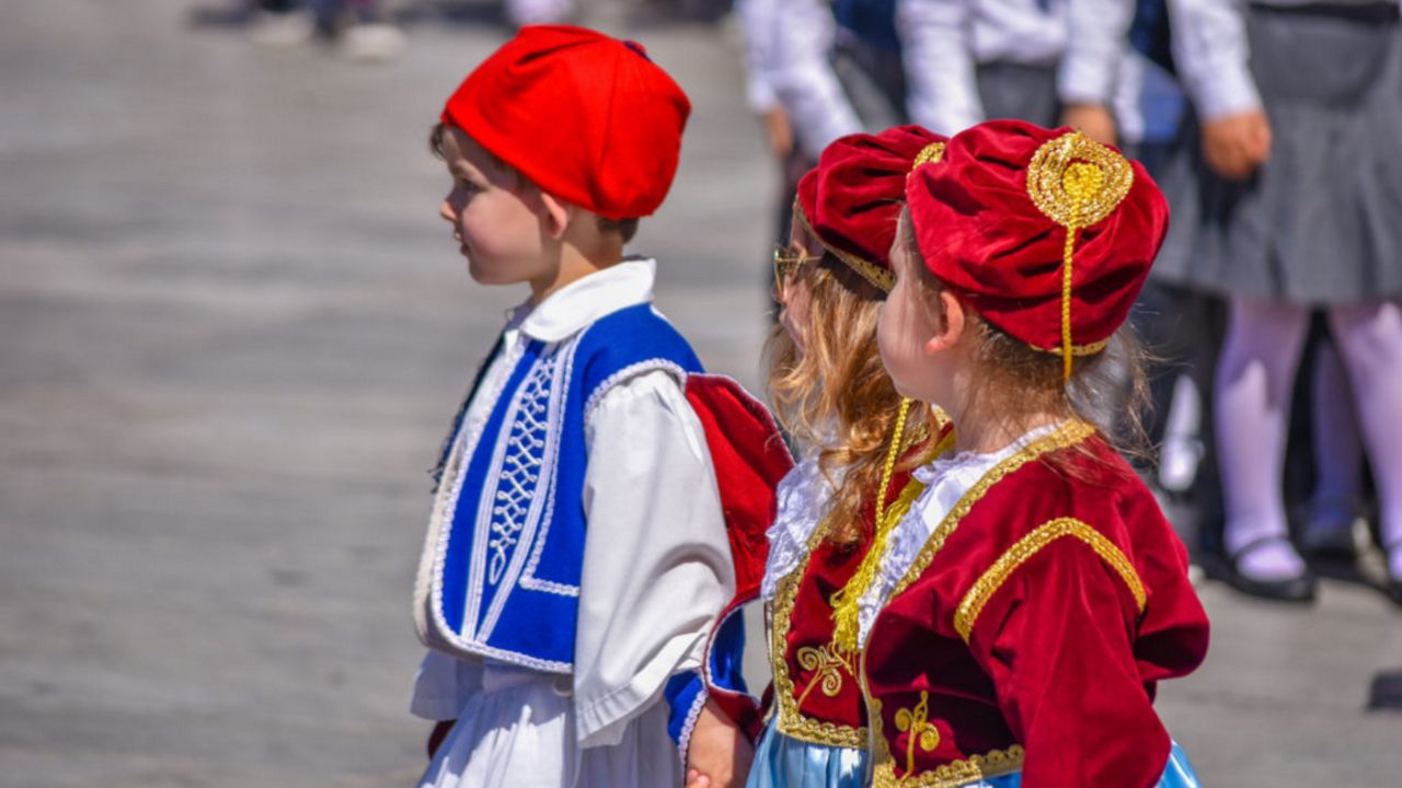 Young kids are dressed in Greek clothing. (Shutterstock)