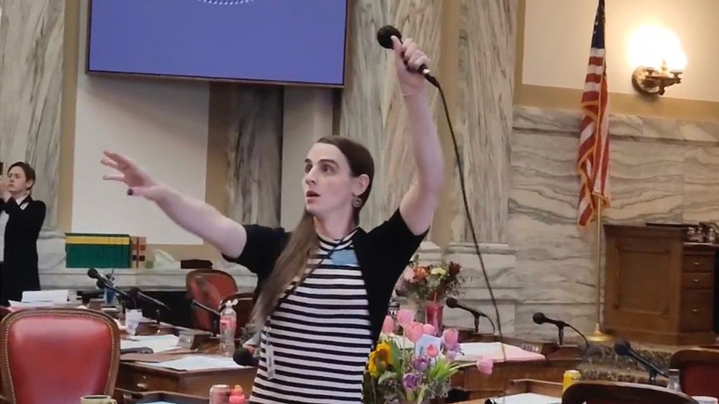 Montana Democratic Rep. Zooey Zephyr hoists a microphone into the air on Monday, April 24, 2023, as her supporters interrupt proceedings in the state House by chanting "Let Her Speak!" in Helena, Mont. (AP Photo/Amy Beth Hanson, File)