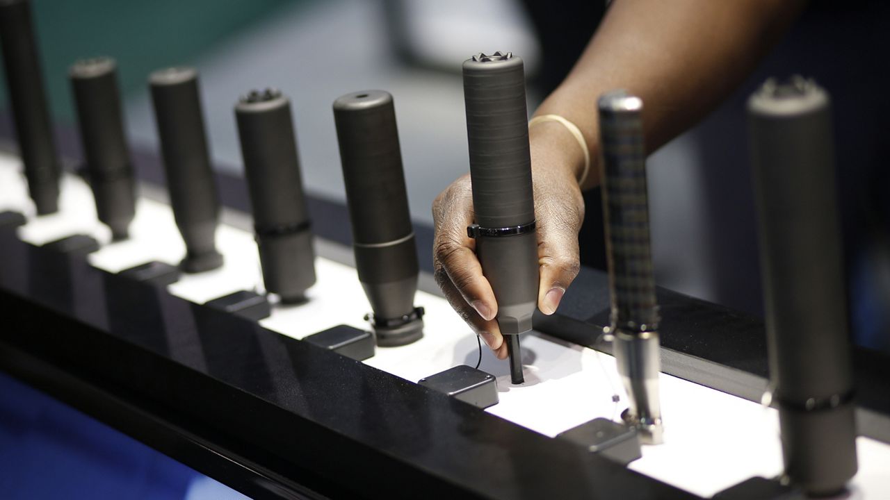 Gun silencers are on display at the Sig Sauer booth at the Shooting, Hunting and Outdoor Trade Show in Las Vegas, Jan. 19, 2016. (AP Photo/John Locher, File)