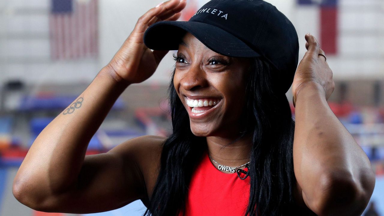 Olympic gold medalist Simone Biles Owens is interviewed after training at the Stars Gymnastics Sports Center in Katy, Texas, Monday, Feb. 5, 2024. (AP Photo/Michael Wyke)