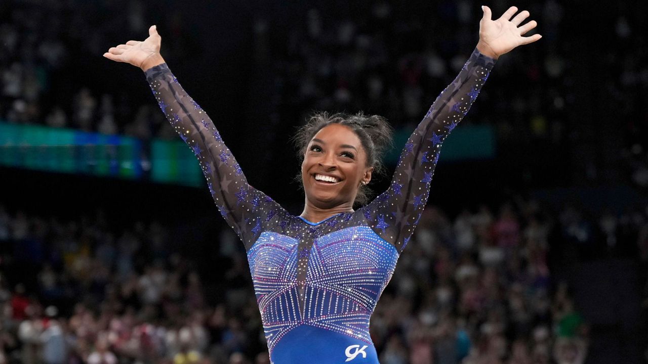 Simone Biles, of the United States, celebrates after performing in the floor exercise during the women's artistic gymnastics all-around finals in Bercy Arena at the 2024 Summer Olympics, Thursday, Aug. 1, 2024, in Paris, France. (AP Photo/Charlie Riedel)